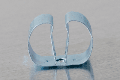 close up of a spring steel gripper clip, tool clip, durable, secure holding, Excellent corrosion and wear resistance, good outdoor weather resistance, mounting hole, made in the usa, silver zinc chromate , 00050198000009
